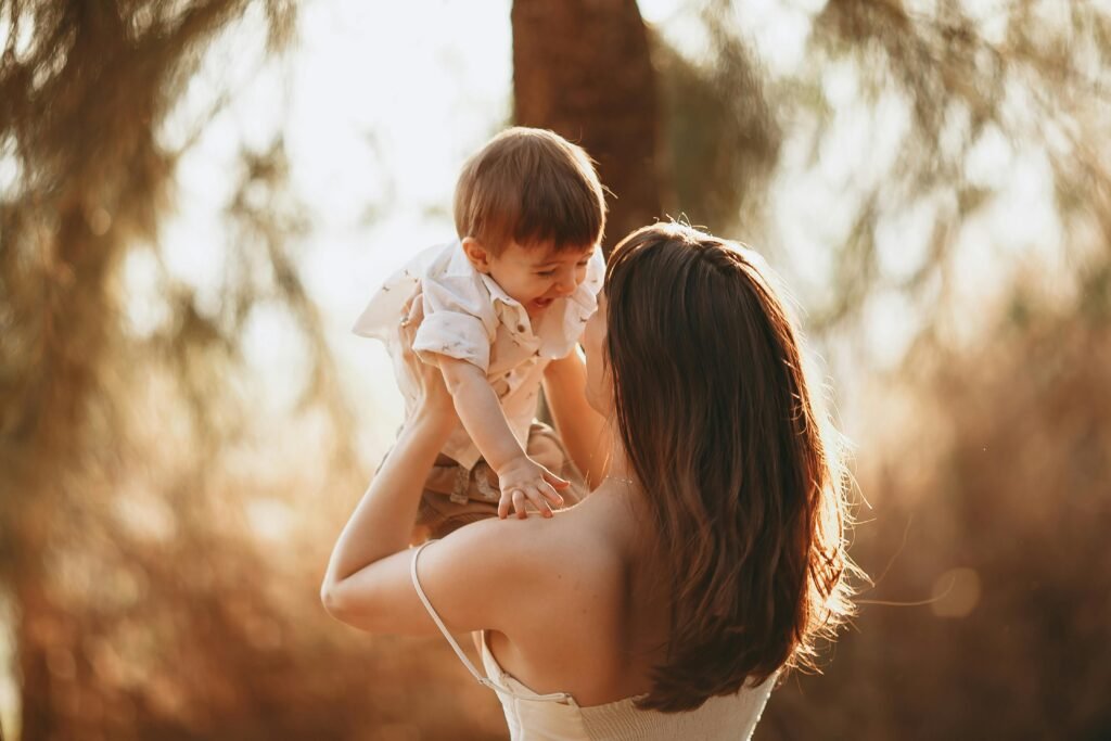 A Woman Carrying a Young Boy - Featured