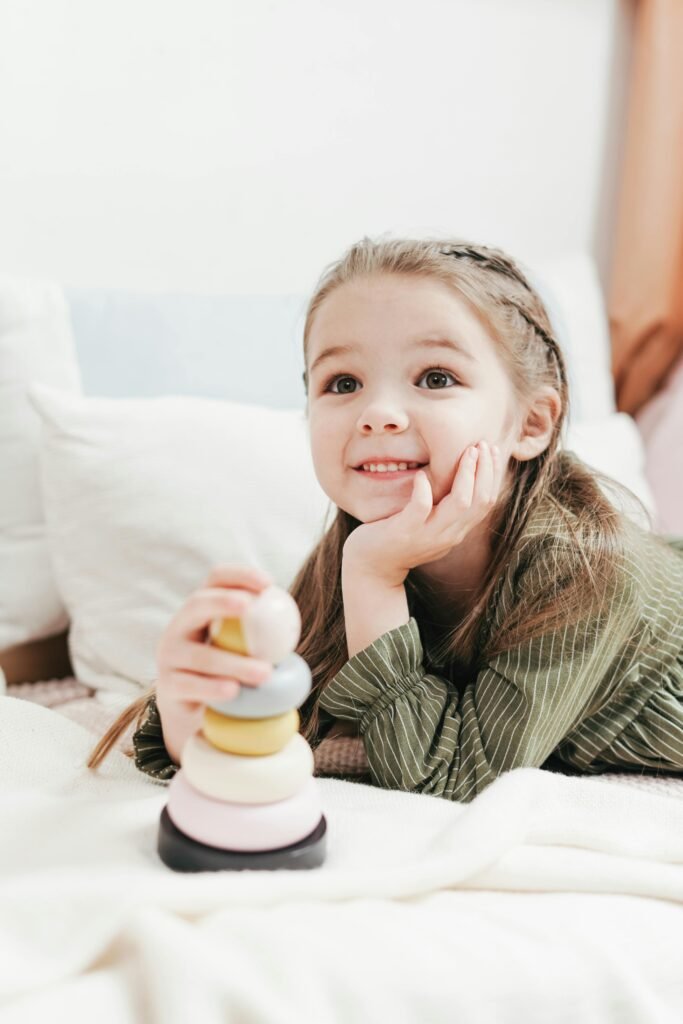 Happy Kid Lying On White Bed - Featured